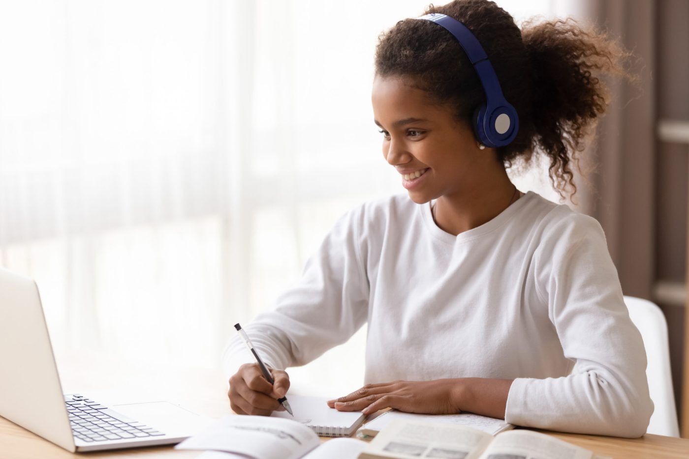 schoolgirl e-learning using headphones and computer